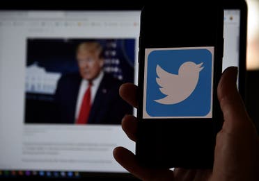 In this photo illustration, a Twitter logo is displayed on a mobile phone with President Trump’s Twitter page shown in the background on May 27, 2020, in Arlington, Virginia. (AFP)