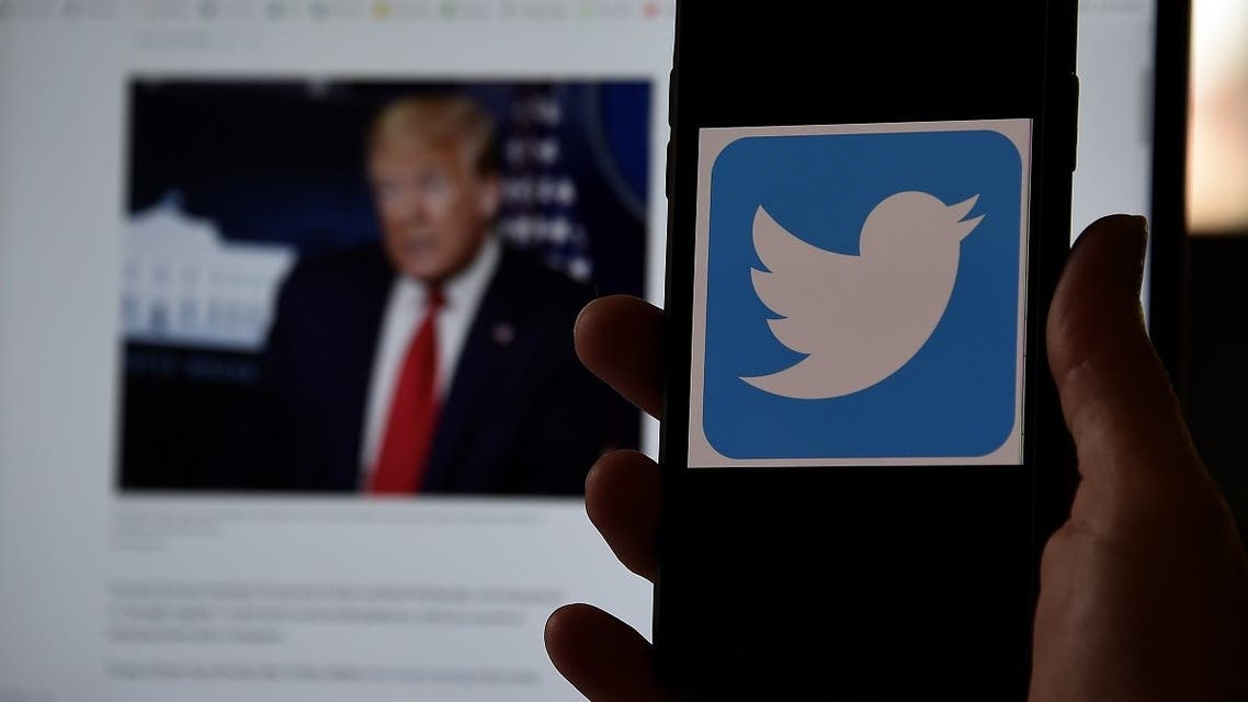 In this photo illustration, a Twitter logo is displayed on a mobile phone with President Trump’s Twitter page shown in the background on May 27, 2020, in Arlington, Virginia. (AFP)