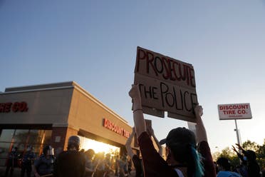 Demonstrators gather in front of a tire store Thursday, May 28, 2020, in St. Paul, Minneapolis as protests broke out for a third straight night. (AP)