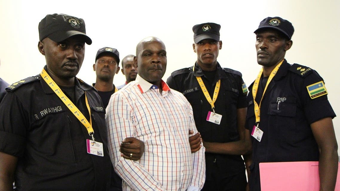 Ladislas Ntaganzwa (C) is escorted by police officers upon his arrival at the airport of Kigali, on March 20, 2016. (File photo: AFP)