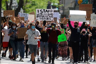 Participants walk with their hands in the air down the 16th Street Mall during a protest over the death of George Floyd, Friday, May 29, 2020, in Denver. More than 1,000 protesters walked from the Capitol down the 16th Street pedestrian mall during the protest. (AP)