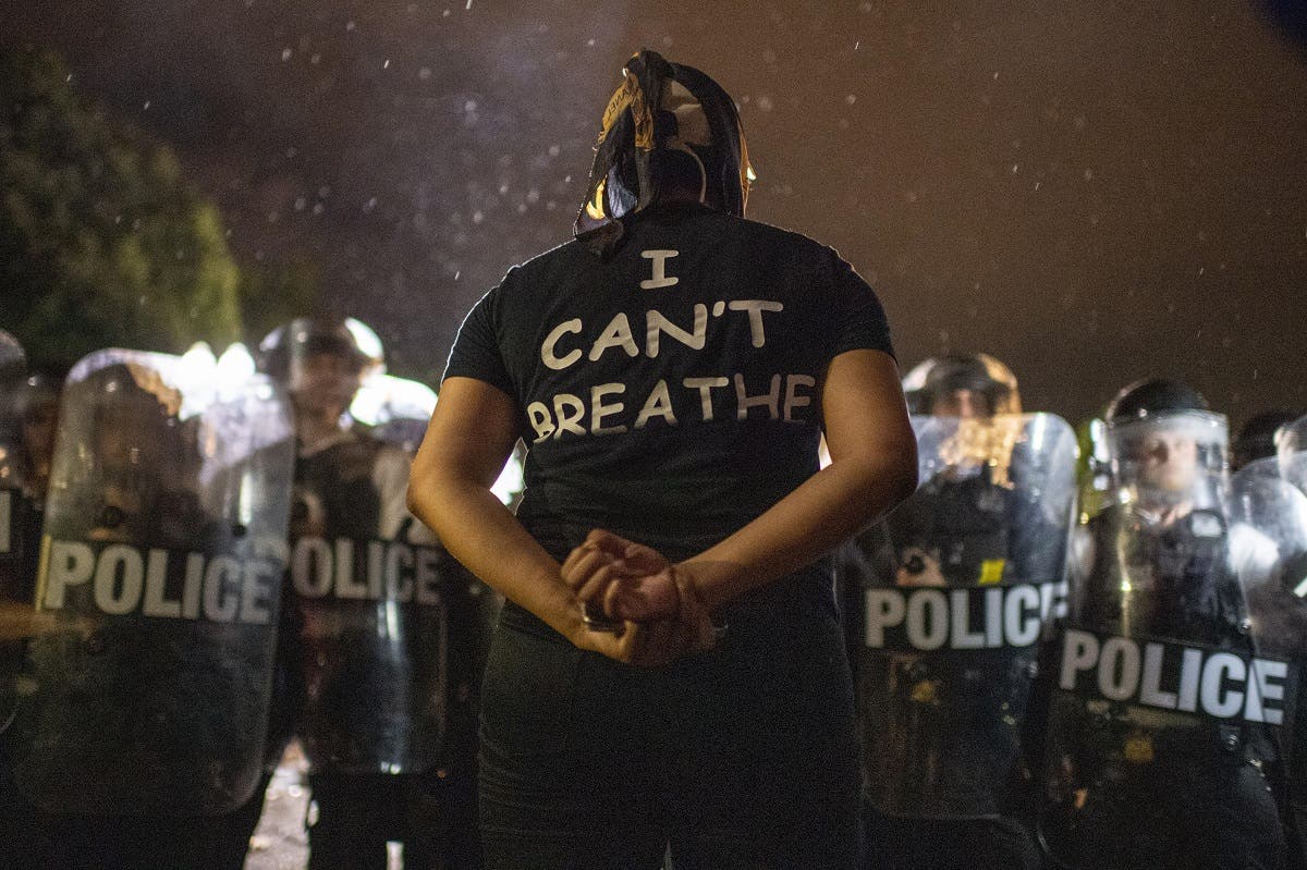 Protesters face off with police outside the White House in Washington, DC, early on May 30, 2020 during a demonstration over the death of George Floyd. (AFP)
