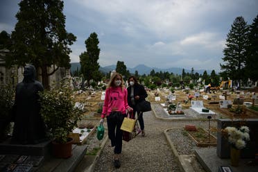 People walk across the Monumental Cemetery of Bergamo, Lombardy, a day after it reopened on May 19, 2020 as the country’s is easing its lockdown. (AFP)