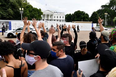 Protesters hold up their hands during a demonstration outside the White House in Washington, DC, on May 29, 2020 over the death of George Floyd. (AFP)