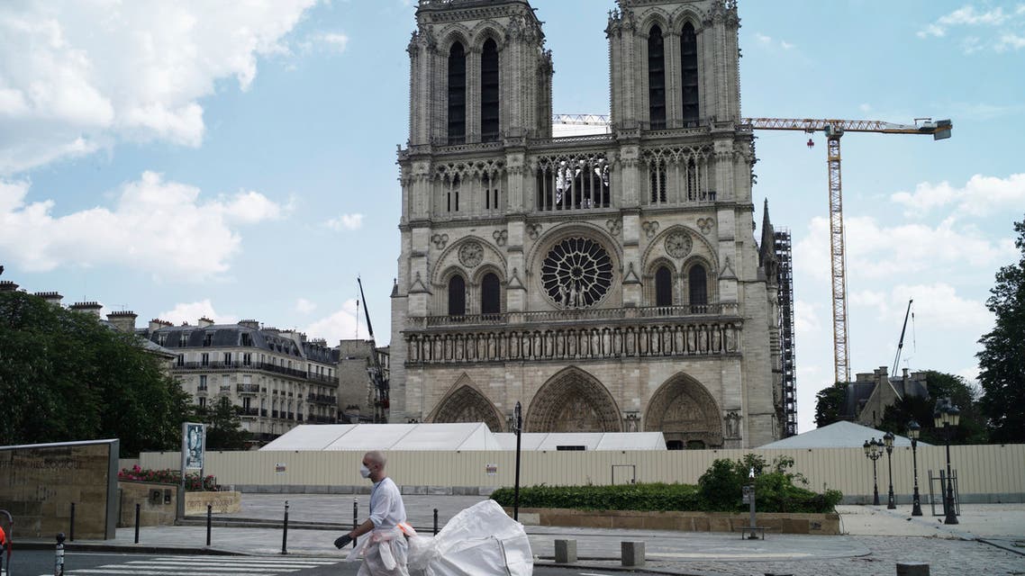 A worker cleans around the Notre Dame Cathedral during nationwide confinement measures to counter the COVID-19 pandemic, in Paris, Monday, April 27, 2020. (AP)
