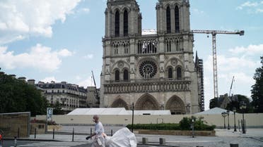 A worker cleans around the Notre Dame Cathedral during nationwide confinement measures to counter the COVID-19 pandemic, in Paris, Monday, April 27, 2020. (AP)