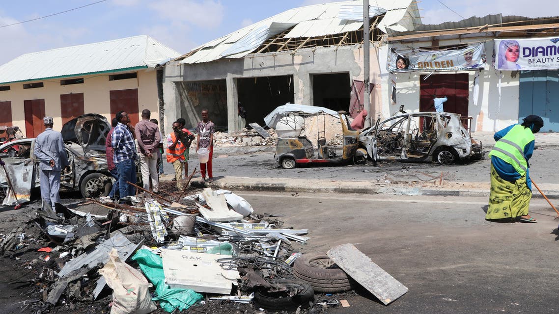 People collect debris at the site where a car bomb exploded near the Somali parliament in Mogadishu, Somalia, on January 8, 2020. At least four people were killed and 10 wounded when a car bomb exploded close to a checkpoint near Somalia's parliament in the capital Mogadishu on January 8, 2020, police said.