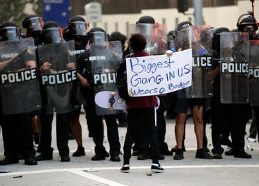 A lone protester confronts a line of police during a demonstration next to the city of Miami Police Department, Saturday, May 30, 2020, downtown in Miami. (AP)
