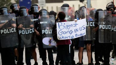 A lone protester confronts a line of police during a demonstration next to the city of Miami Police Department, Saturday, May 30, 2020, downtown in Miami. (AP)