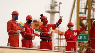 Workers of the state-oil company Pdvsa holding Iranian and Venezuelan flags greet during the arrival of the Iranian tanker ship Fortune at El Palito refinery in Puerto Cabello, Venezuela May 25, 2020. (Reuters)