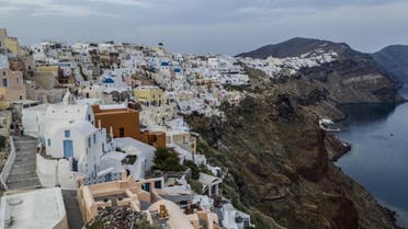 White washed villas adorn the cliffs of the village of Oia, on the northwestern tip of the Greek island of Santorini, in the Aegean Sea on May 20, 2020.  (AFP)