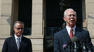 File photo of Boente (R), speaks while flanked by Andrew G. McCabe (L), Assistant Director in Charge of the FBI’s Washington Field Office, after a hearing in federal court June 11, 2015 in Alexandria, Virginia. (AFP)