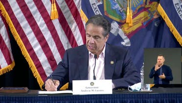 In this image made from video provided by the office of Gov. Andrew M. Cuomo, Gov. Cuomo signs a bill giving death benefits to the families of certain government workers who were killed by coronavirus, Saturday, May 30, 2020 in New York. (AP)