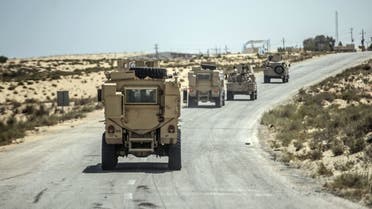 A picture taken on July 26, 2018 shows Egyptian policemen driving on a road leading to the North Sinai provincial capital of El-Arish. (AFP)