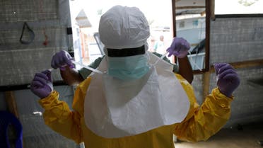 FILE PHOTO: A health worker puts on Ebola protection gear before entering the Biosecure Emergency Care Unit (CUBE) at the ALIMA (The Alliance for International Medical Action) Ebola treatment centre in Beni, in the Democratic Republic of Congo, March 31, 2019. Picture taken March 31, 2019.REUTERS/Baz Ratner/File Photo