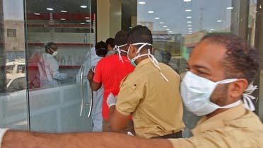 Mask-clad health workers enter the private al-Kubi Hospital in Yemen's southern coastal city of Aden on May 17, 2020, amid fears that coronavirus is spreading unhindered in the Yemeni city. Deaths in Aden have surged to five or even seven times higher than normal, an NGO and medics say. Six years of war against the Huthis -- and a widening fault-line among forces opposed to that rebel outfit -- have left authorities ill-equipped to control the spread of the virus. 