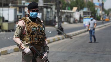 A member of the Iraqi security forces stands guard at a checkpoint, enforcing a curfew due to the COVID-19 coronavirus pandemic, in Baghdad's eastern Sadr City suburb on May 31, 2020. The Iraqi authorities imposed a week-long curfew to curb the latest increase in infections of coronavirus in the country.
