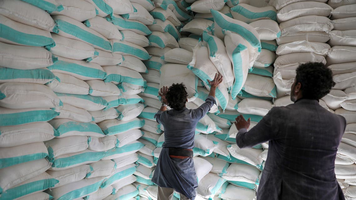 Workers handle sacks of wheat flour at a World Food Programme food aid distribution center in Sanaa, Yemen February 11, 2020. REUTERS/Khaled Abdullah