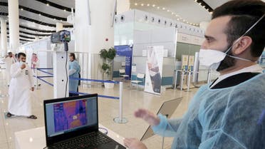 A security man looks at a screen showing the body temperature of travellers, at Riyadh International Airport, after Saudi Arabia reopened domestic flights, following the outbreak of the coronavirus disease (COVID-19), in Riyadh, Saudi Arabia May 31, 2020. REUTERS/Ahmed Yosri