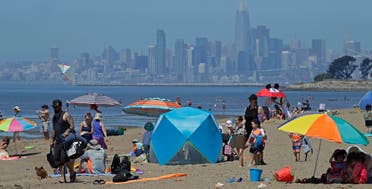 People congregate on Robert W. Crown Memorial State Beach with the San Francisco skyline as a backdrop on May 26, 2020, in Alameda, Calif. (AFP)
