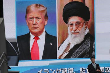A man walks by a huge screen showing U.S. President Donald Trump, left, and Iranian Supreme Leader Ayatollah Ali Khamenei, in Tokyo, Wednesday, Jan. 8, 2020. (AP)
