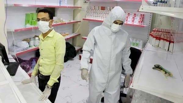 In this May 12, 2020 photo, Yemeni medical workers wearing masks and protective gear stand at the entrance of a hospital in Aden, Yemen. (AP)
