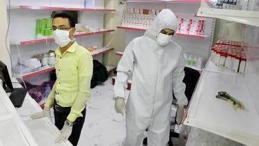 In this May 12, 2020 photo, Yemeni medical workers wearing masks and protective gear stand at the entrance of a hospital in Aden, Yemen. (AP)