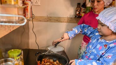This photo taken on May 21, 2020 shows young chef Moe Myint May Thu cooking at home in Yangon. (AFP)