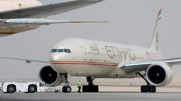 An engineer walks near an Etihad Airways aircraft at Abu Dhabi International Airport. (Reuters)