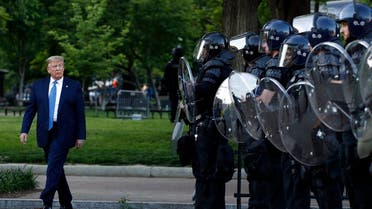 Trump walks past police in Lafayette Park after he visited outside St. John's Church across from the White House Monday, June 1, 2020, in Washington. (AP)