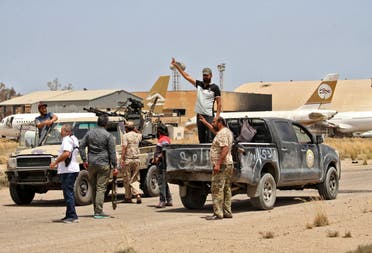 Fighters loyal to the UN-recognised Libyan Government of National Accord (GNA) stand outside a technical (pickup truck mounted with turret) at Tripoli International Airport, on the southern outskirts of the Libyan capital Tripoli on June 4, 2020.