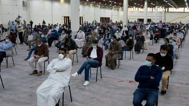 Expatriates wait for mandatory coronavirus testing in a makeshift testing centre in Mishref, Kuwait March 14, 2020.(Reuters)