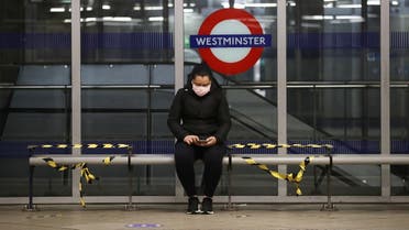 A woman wearing a protective face mask is seen at Westminster tube station. (Reuters)