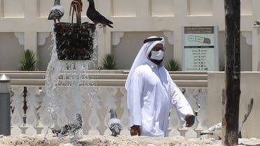 A man wearing a ptotective mask walks by a water fountain at Qatar's touristic Souq Waqif bazar in the capital Doha, on May 17, 2020, as the country begins enforcing the world's toughest penalties for failing to wear masks in public while it battles one of the world's highest coronavirus infection rates. More than 30,000 people have tested positive for COVID-19 in the tiny Gulf country, 1.1 percent of the 2.75 million population, although just 15 people have died. Violators of the new rules will face up to three years in jail and fines of as much as $55,000.