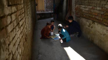 Children play Ludo game on a street during a government-imposed nationwide lockdown as a preventive measure against the COVID-19 coronavirus, in Rawalpindi on May 5, 2020. (File photo: AFP)