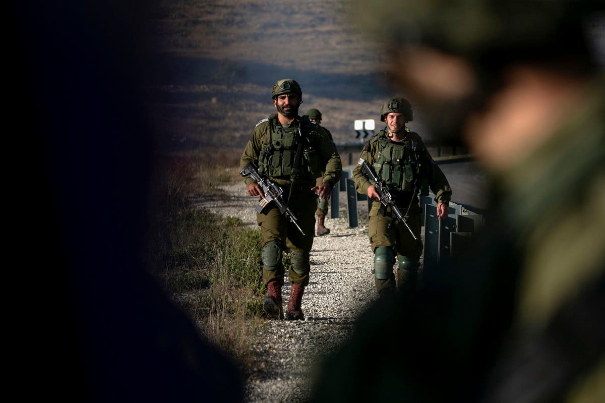 Israeli soldiers stand guard near the scene of a reported car-ramming attack north of the city of Ramallah in the Israeli-occupied West Bank, on May 29, 2020. (File photo: AFP)
