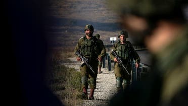 Israeli soldiers stand guard near the scene of a reported car-ramming attack north of the city of Ramallah in the Israeli-occupied West Bank, on May 29, 2020. (AFP)