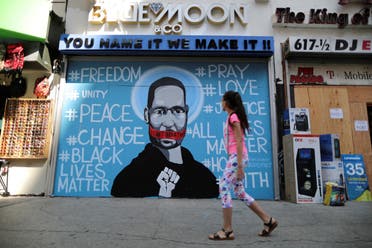 A girl walks past a mural commemorating George Floyd, in downtown Los Angeles, California, U.S. June 4, 2020. (Reuters)