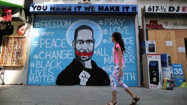 A girl walks past a mural commemorating George Floyd, in downtown Los Angeles, California, U.S. June 4, 2020. (Reuters)
