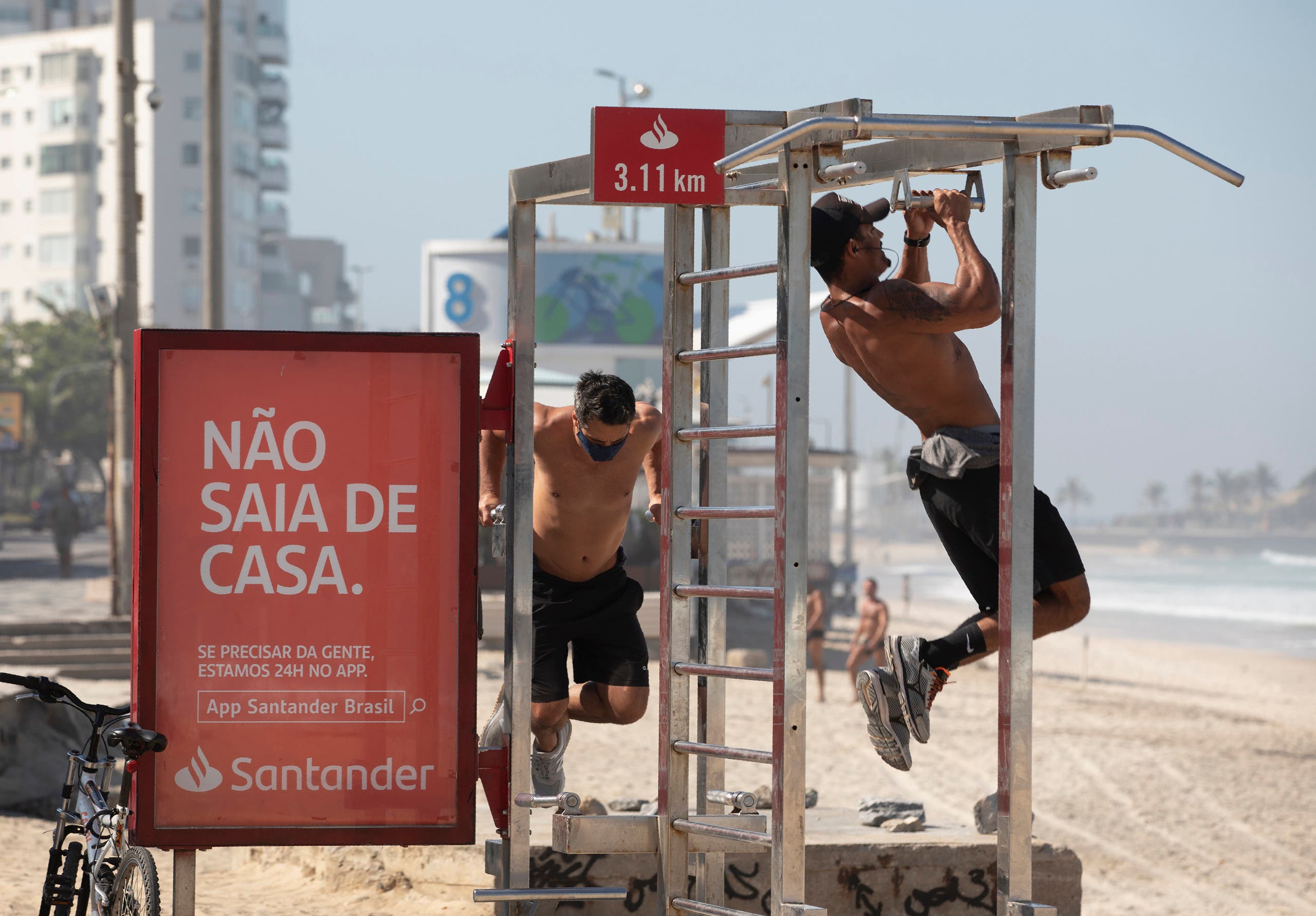 Men exercise on gym equipment on the sidewalk of Ipanema beach in Rio de Janeiro, Brazil on June 2, 2020. (AP)