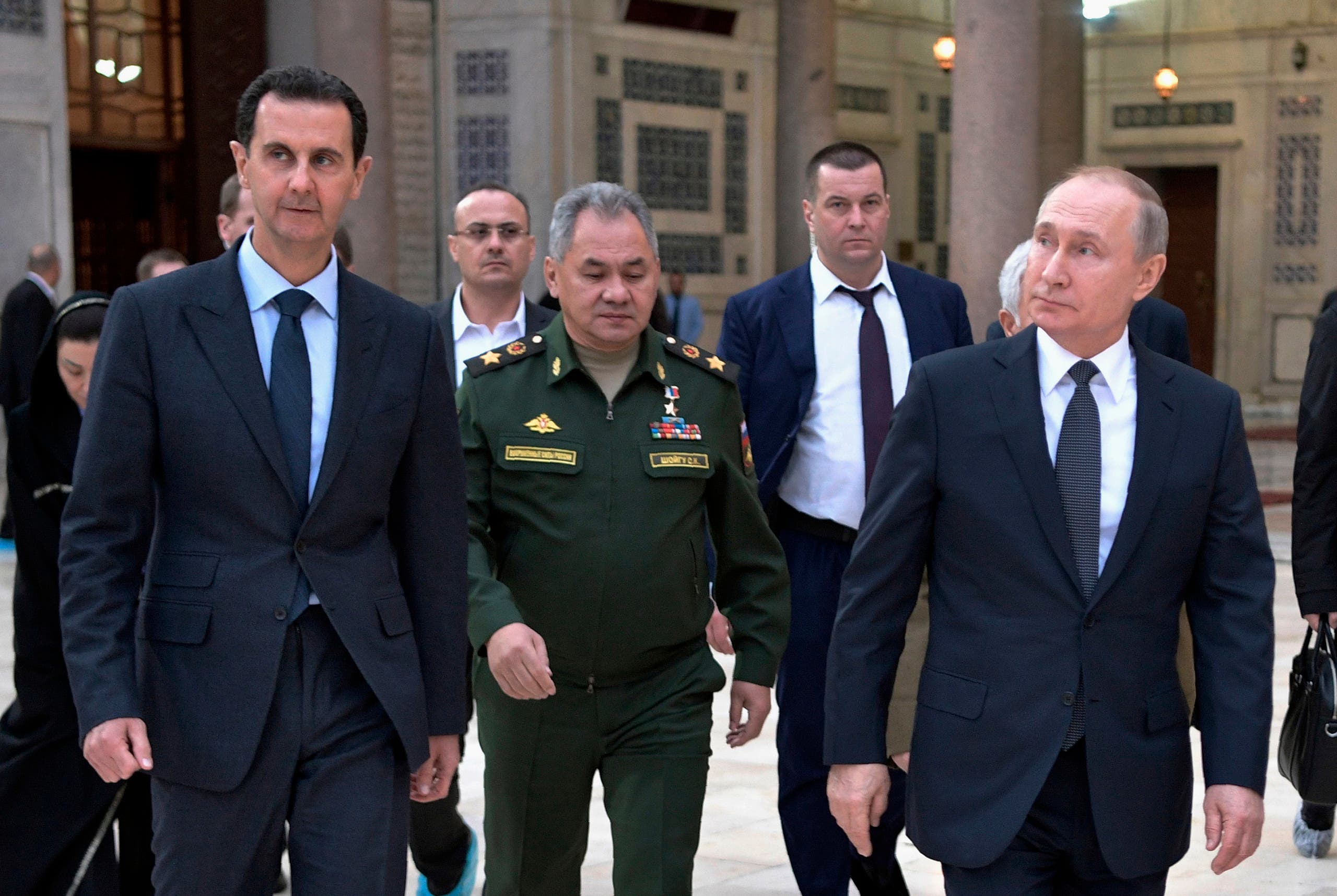 Russian President Vladimir Putin, right, Syrian President Bashar Assad, left, and Russian Defense Minister Sergei Shoigu, center, in Damascus, Syria, Jan. 7, 2020. (AP)