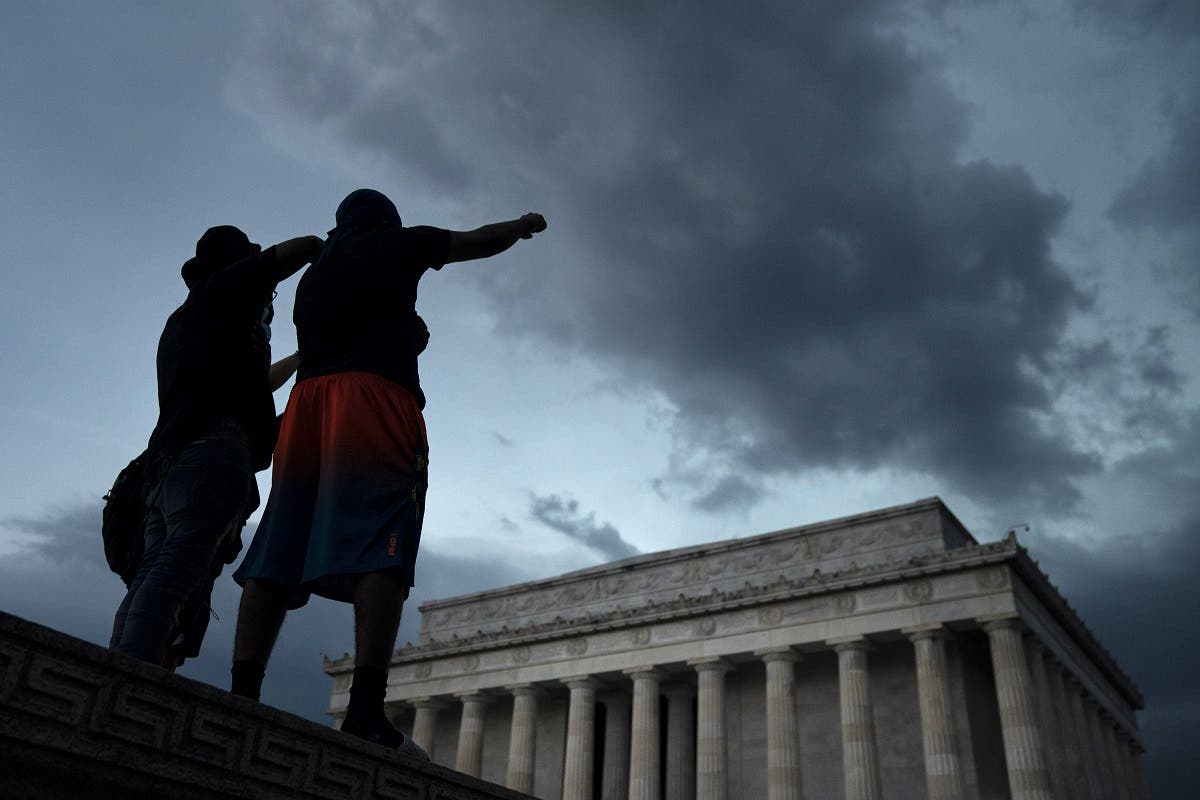 Demonstrators peacefully protest against police brutality and the death of George Floyd at the Lincoln Memorial, on June 4, 2020 in Washington, DC. (AFP)