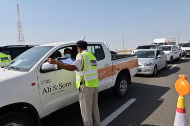 Emirati security forces man a checkpoint at the entrance of Abu Dhabi, on the highway linking Dubai to the capital, on June 2, 2020, after authorities cordoned off the city for a week to rein in the novel coronavirus. (AFP)