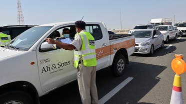 Emirati security forces man a checkpoint at the entrance of Abu Dhabi, on the highway linking Dubai to the capital, on June 2, 2020, after authorities cordoned off the city for a week to rein in the novel coronavirus. (AFP)