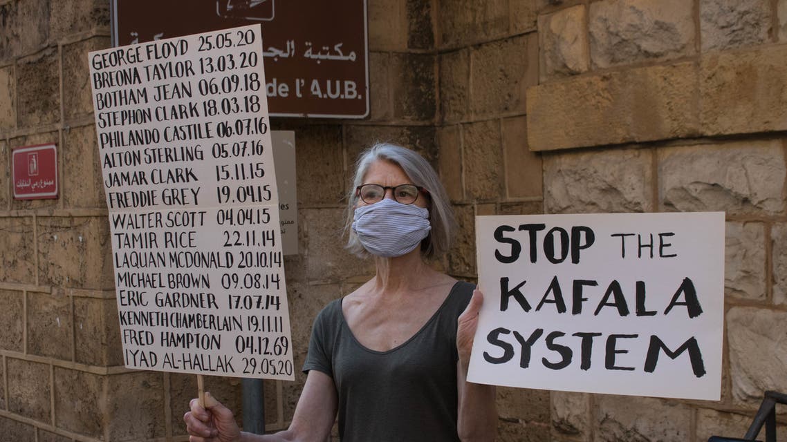 A woman in Lebanon holds signs at a vigil for George Floyd that also highlighted racism in Lebanon. (Nicholas Frakes)