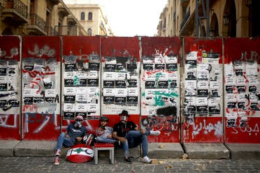 Lebanese protesters sit outside a fortified entrance of the Lebanese parliament during a demonstration in central Beirut on June 6, 2020. (AFP)