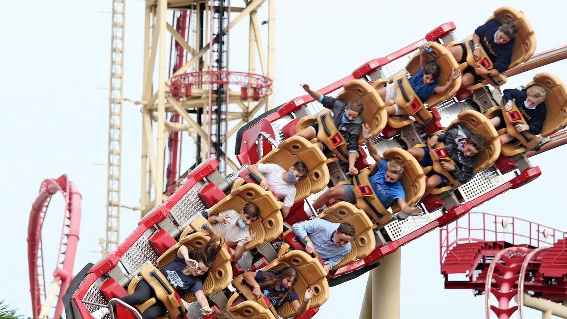 Visitors ride a roller coaster at Universal Studios theme park on the first day of reopening from the coronavirus pandemic. (AFP)