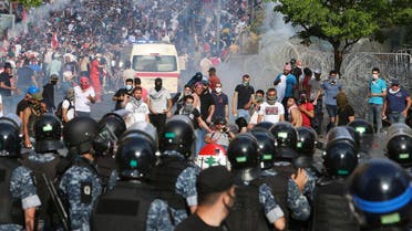 Demonstrators run amid a cloud of tear gas during a protest against the government performance and worsening economic conditions, in Beirut, Lebanon June 6, 2020. REUTERS/Aziz Taher