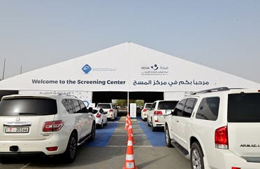 Cars line up as people wait to enter a drive thru testing centre for the COVID-19 coronavirus in the Emirati capital Abu Dhabi on April 2, 2020. (AFP)