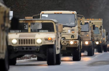 US military vehicles driving along a road at a military training area near Brueck, Germany, Wednesday, Jan. 11, 2017. (AP)